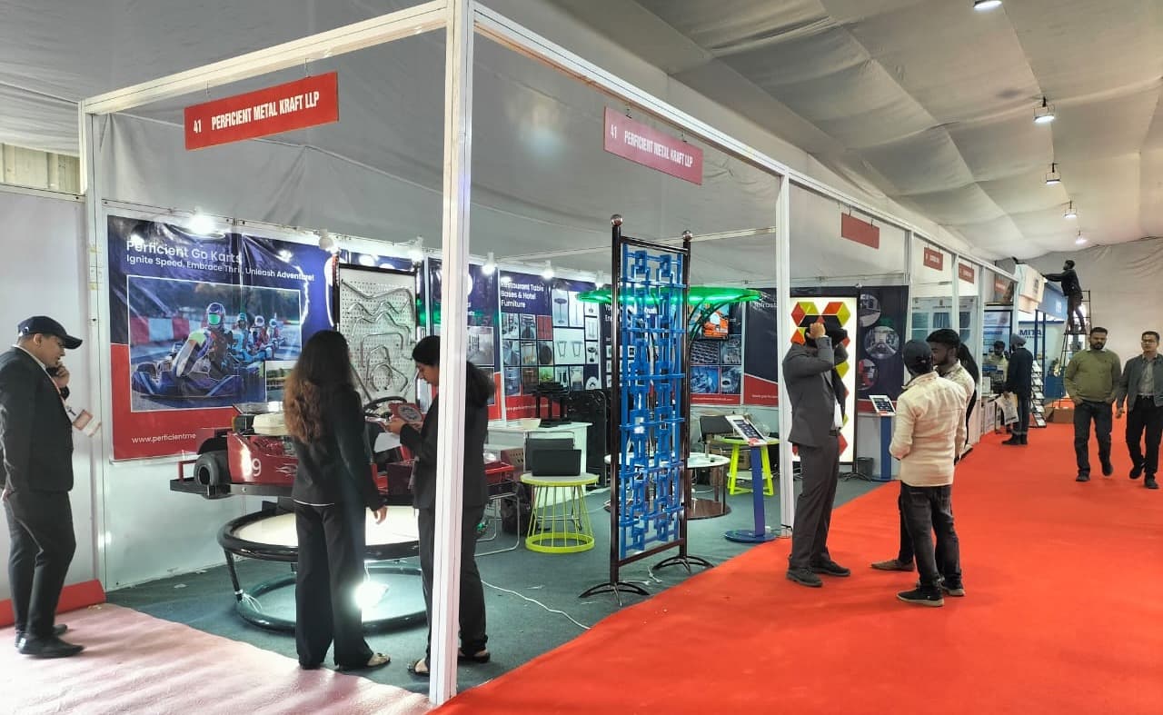 Perficient Metal Kraft LLP exhibition booth showcasing industrial and decorative metal products, including furniture, custom structures, and a go-kart display, highlighting craftsmanship and innovation at a trade show.