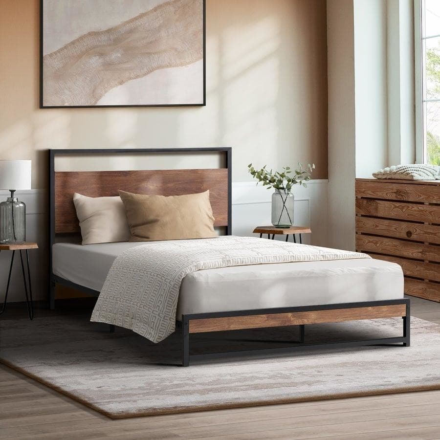 Metal bed with wood panels, soft pillows, and warm-toned decor in a sunlit bedroom.