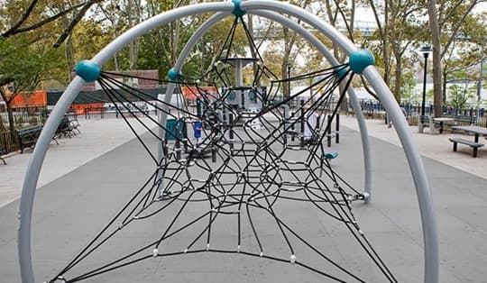Outdoor playground climbing net structure with ropes and metal frame for kids’ physical activity and fun.