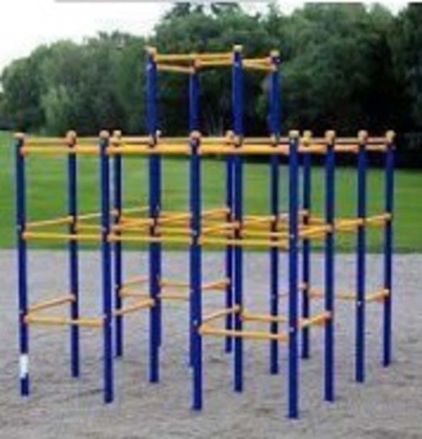 A zig zag metal climbing structure with blue vertical bars and yellow horizontal rungs, set on a gravel surface in a park.